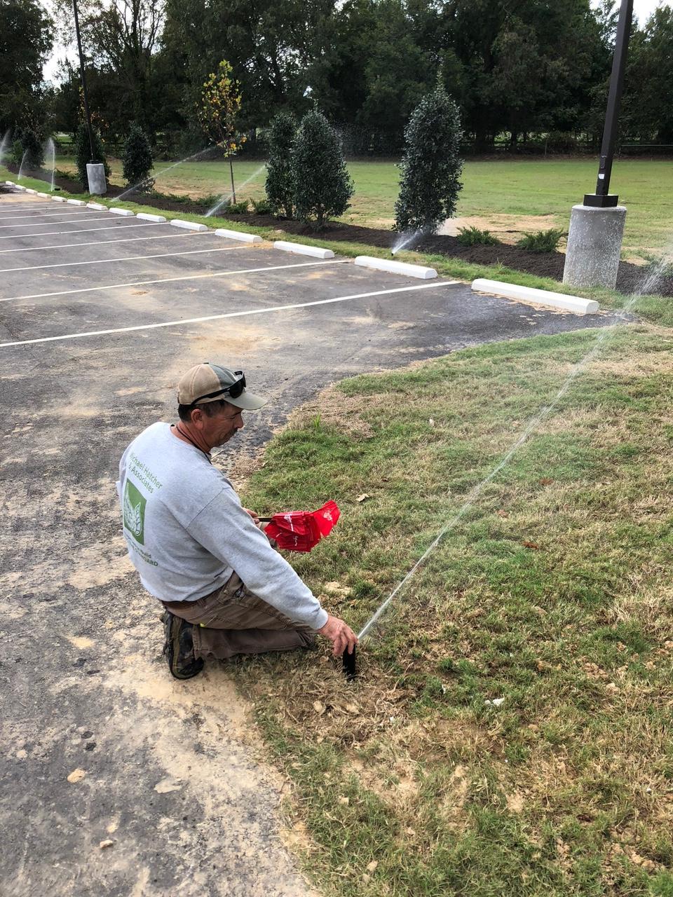 Tommy Neergaard adjusting an irrigation head